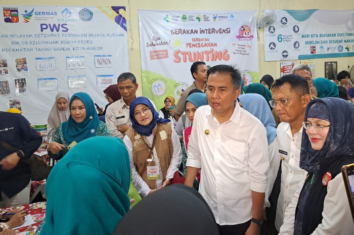 Pj Gubernur Jawa Barat, Bey Machmudin saat mendampingi Jokowi di Puskesmas Wijaya Kusuma, Kecamatan Tanah Sareal pada Selasa (11/6/2024). Bey meminta orang tua tidak berbuat curang dalam PPDB.