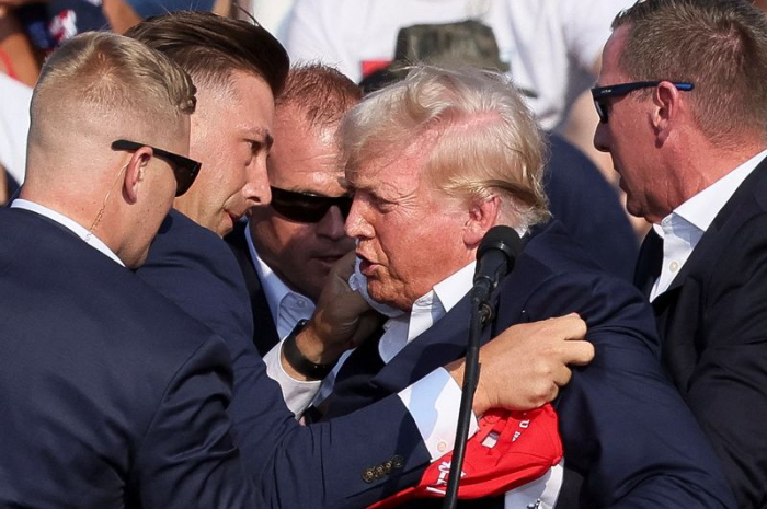 Donald Trump saat dievakuasi petugas keamanan setelah ditembak OTK ketika berkampanye di Pennsylvania.
