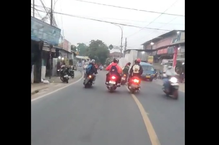 Pelajar ugal-ugalan sembari mengacungkan sajam di Jalan Raya Cibungbulang, Bogor.