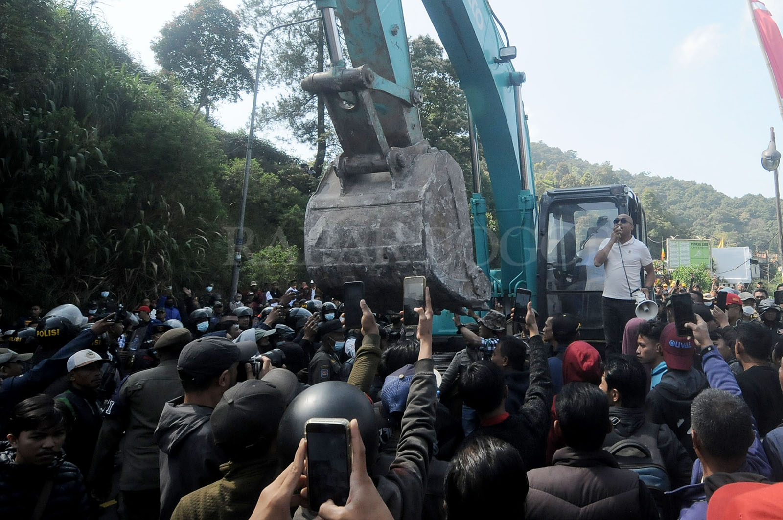 Warga menghalangi alat berat  saat dilakukan pembongkaran 196 bangunan di Puncak, Cisarua. Foto :