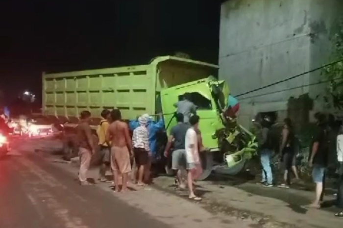 Warga saat berusaha mengevakuasi sopir truk tambang yang alami kecelakaan di Parung Panjang Bogor Senin (2/9/2024) malam.
