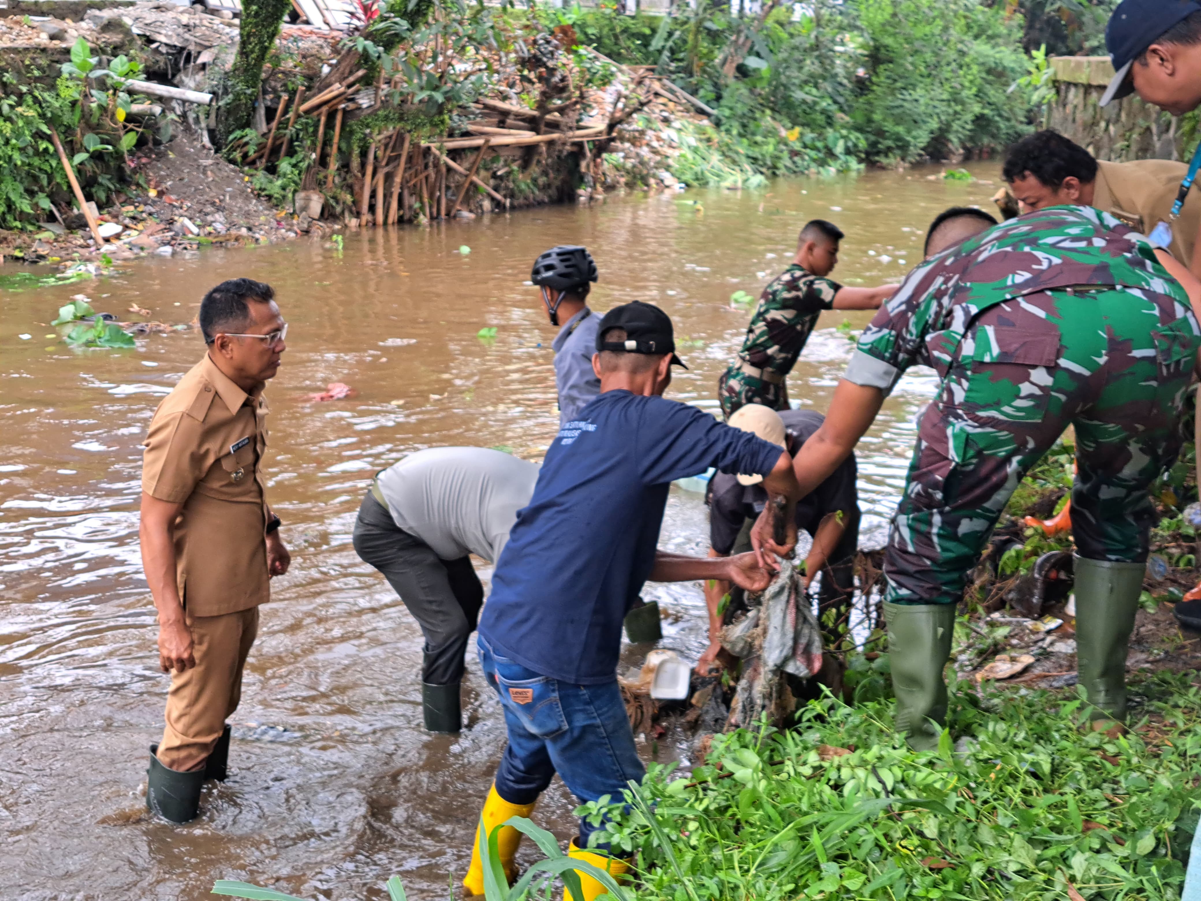 Pj Wali Kota bersama Dandim Kota Bogor serta personel gabungan mengangkat sampah dari Sungai Cipakancilan.