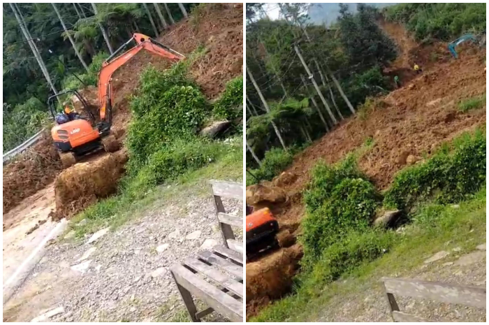 Alat berat tengah memindahkan material longsoran yang menutup akses Jalur Puncak Dua.