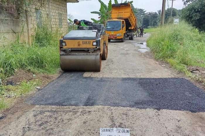 Pengoperasian alat berat oleh pekerja dalam pemeliharaan infrastruktur jalan di beberapa wilayah Kabupaten Bogor.