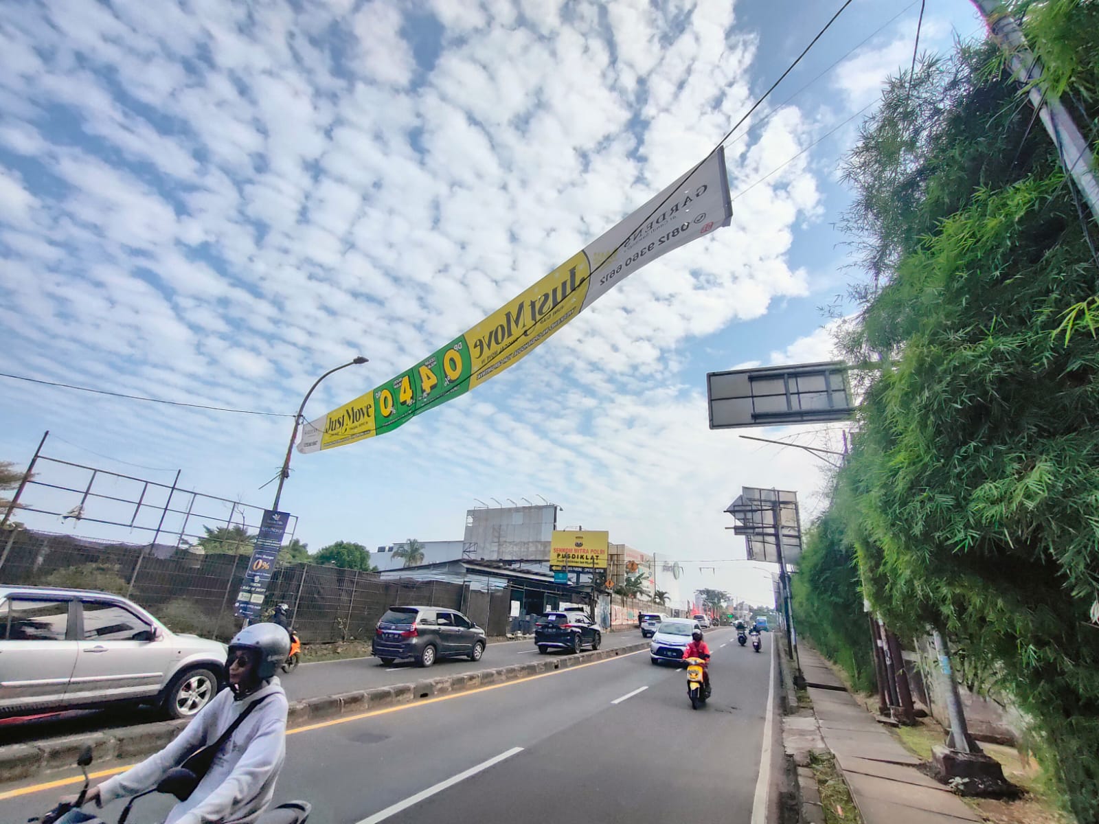 Penampakan spanduk liar yang melintang di tengah Jalan Raya  Parung-Ciputat Kota Depok.