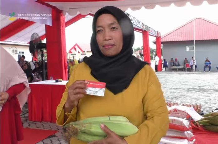 Ilustrasi KPM yang sedang memegang kartu KKS merah putih
