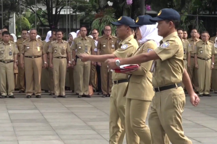 DIRENCANAKAN NAIK GAJI: Para PNS bersiap mengibarkan bendera saat upacara.