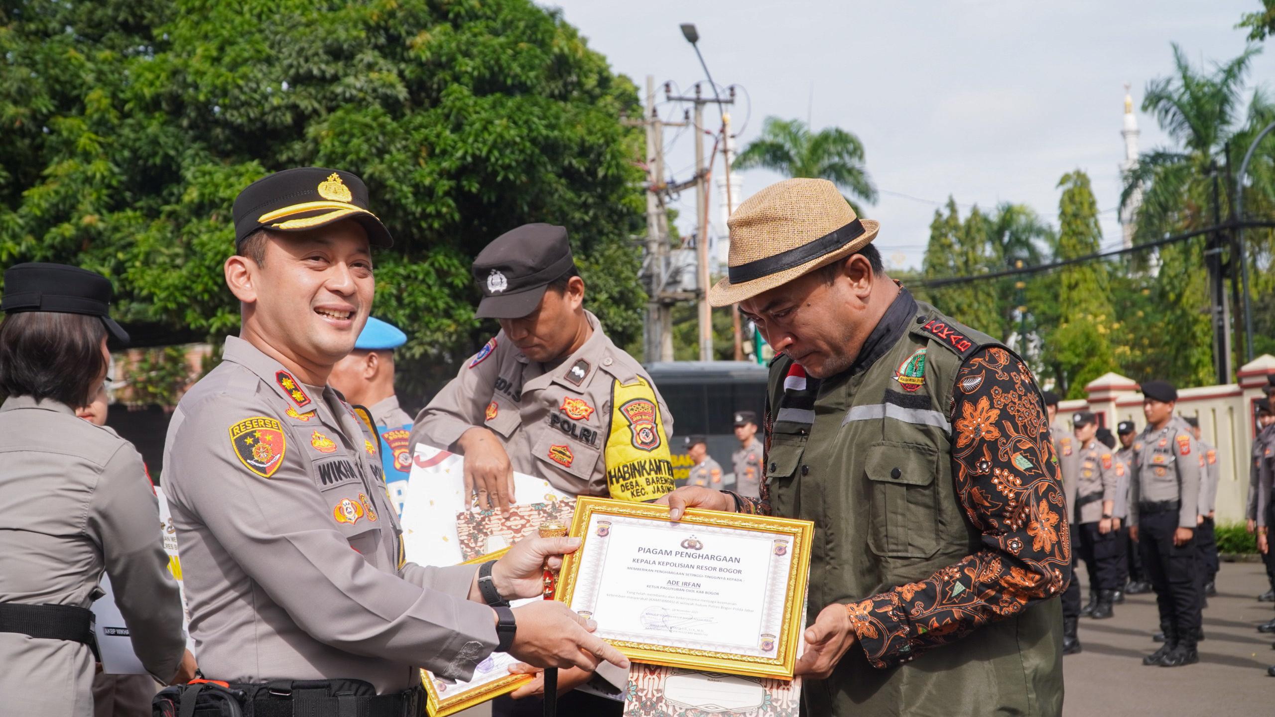 Ade Irfan, saat menerima simbolis hadiah umroh dari Kapolres Bogor, AKBP Wikha Ardilestanto.