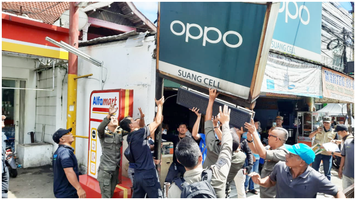 Petugas Satpol PP saat menertibkan reklame tak berizin di Jalur Puncak Bogor.