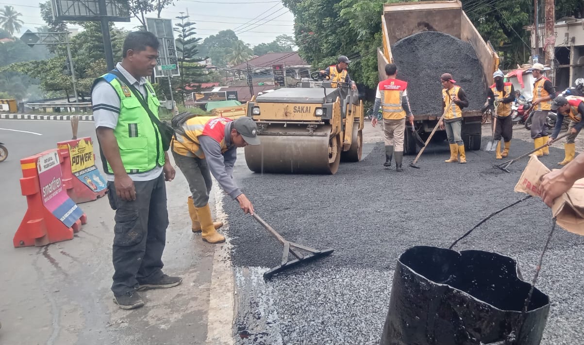 Petugas UPT Infrastruktur Jalan dan Jembatan Wilayah II Ciawi saat mengaspal Simpang Pasir Angin, Megamendung. Jalur alternatif Puncak itu kini terlihat rapih.