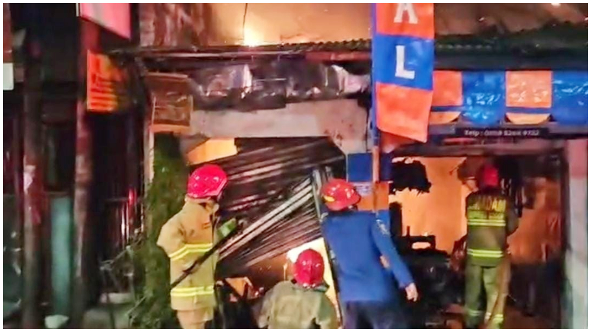 Petugas damkar saat memadamkan toko terpal di Kelurahan Pakansari, Kecamatan Cibinong, Kabupaten Bogor yang terbakar.