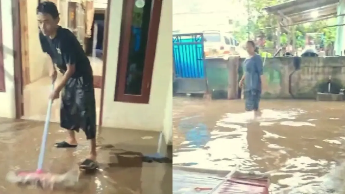 Warga RW 02, Leuwiranji, Rumpin Bogor membersihkan sisa banjir di rumahnya.