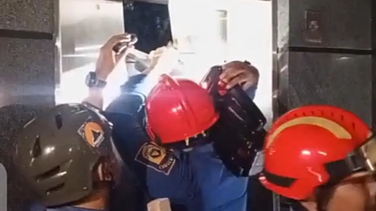 Petugas Damkar Kabupaten Bogor saat mengevakuasi dua wanita terjebak dalam lift. (Tangkapan layar video Damkar)