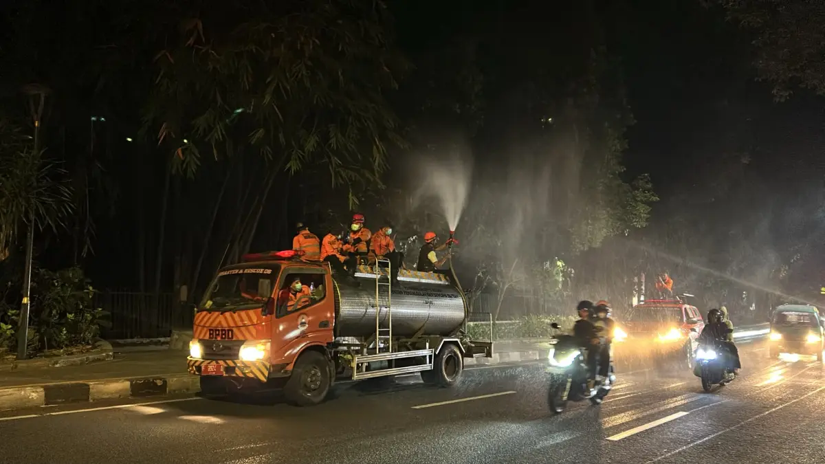 Petugas Damkar Kota Bogor saat menyemprot jalan. (Fauzan/Radar Bogor)