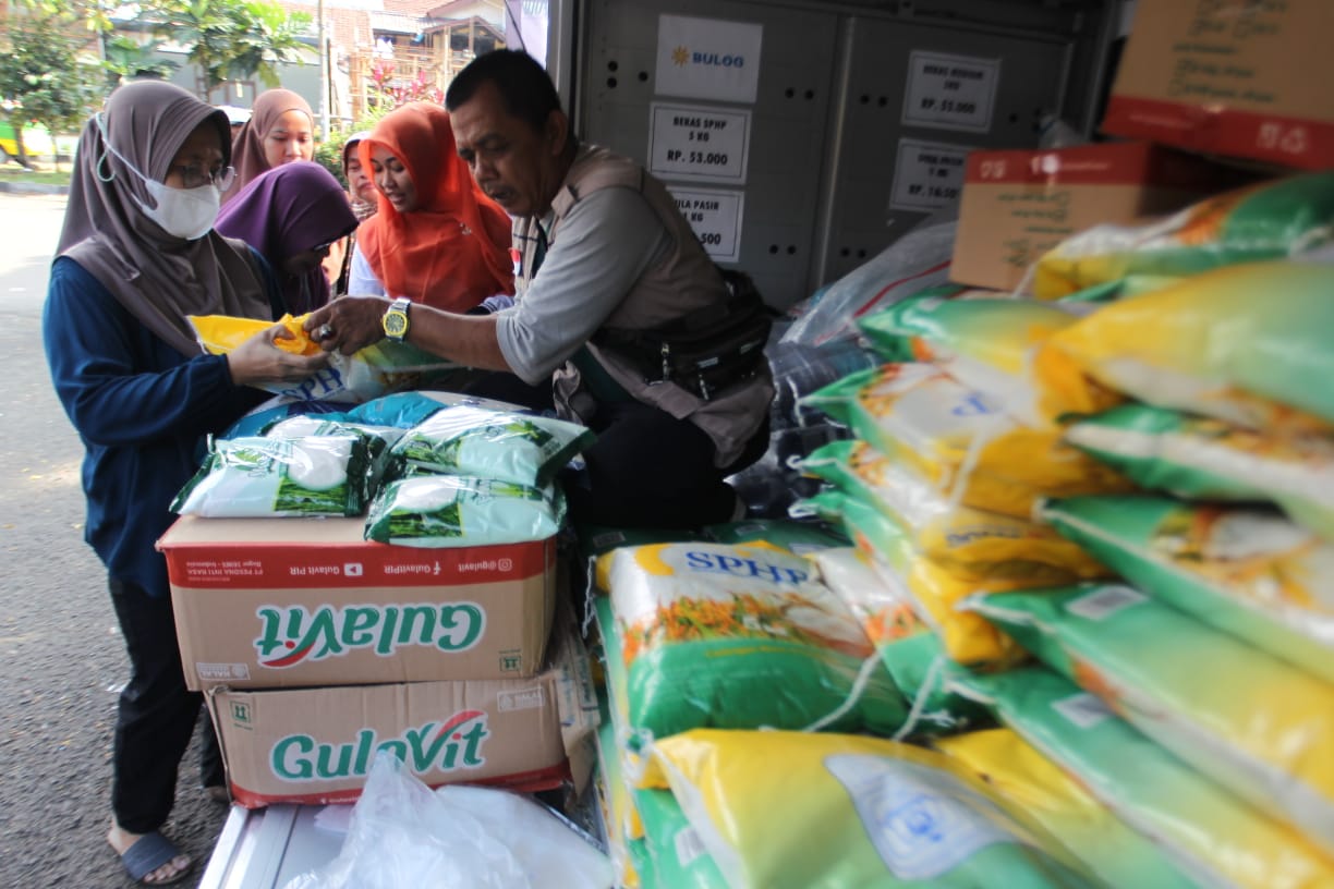 Sejumlah warga mengantri untuk membeli beras saat pelaksanaan Pasar Murah Beras SPHP Bulog (Bulog Siaga) bersama Bulog dan Tim Pengendali Inflasi Daerah (TPID) di komplek perumahan  Cimanggu Barata , kelurahan Kedung Badak, Kecamatan Tanah Sareal, Jumat,(