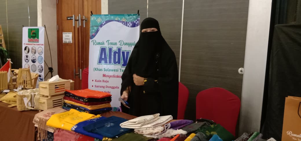 ALAMI TREN PENINGKATAN : Salah satu pelaku usaha kain tenun di Kota Palu, Feby, saat ditemui Radar Palu disela-sela kegiatan Misi Dagang dan Investasi, Sabtu (19/10/2025).