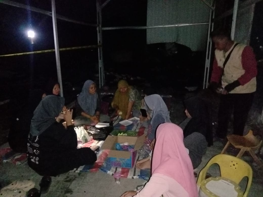 MENGUNGSI: Suasana makan malam mahasiswa bersama warga di tempat pengungsian korban kebakaran Asrama Parigi, Kamis (13/11/2025).