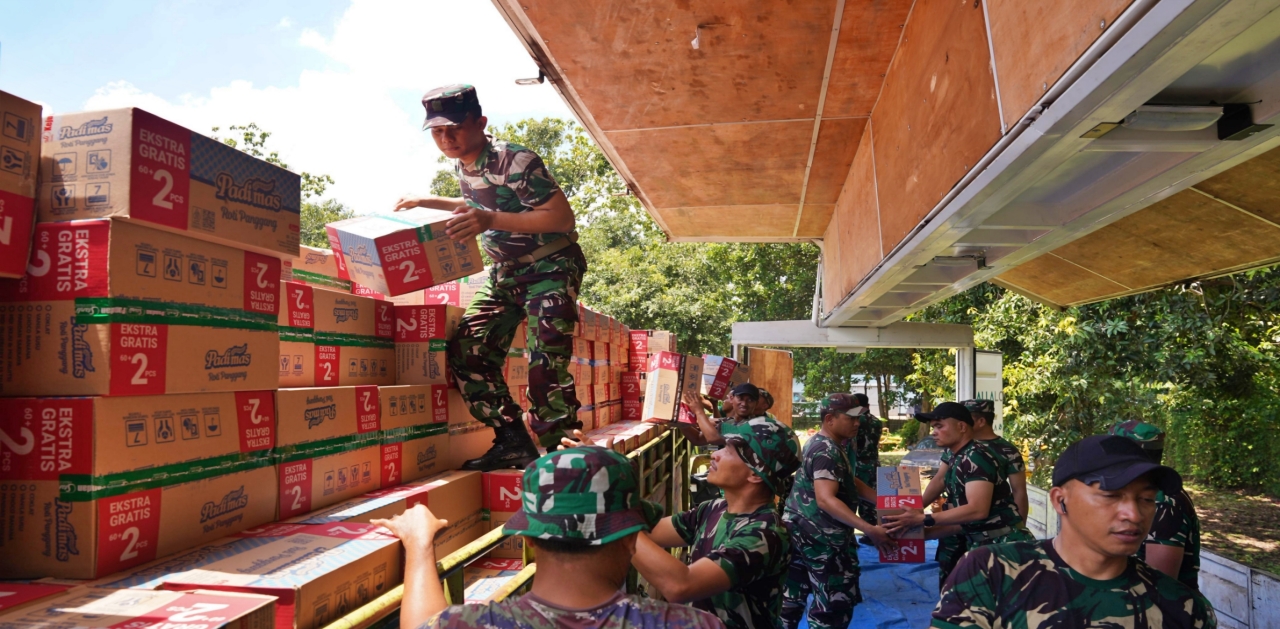 KOLABORASI - Prajurit TNI membantu penyaluran bantuan kemanusiaan dari Trinusa Group untuk untuk masyarakat terdampak bencana alam. (FOTO: ISTIMEWA/RADAR PALU)