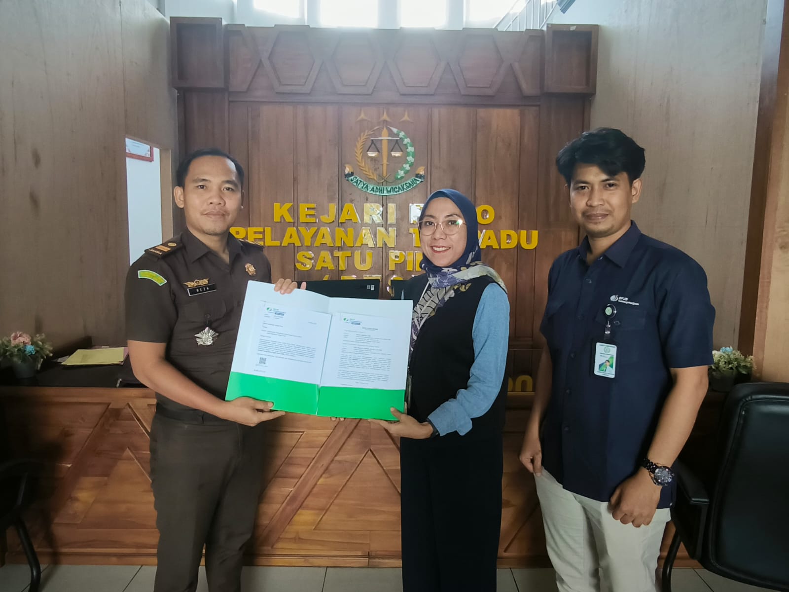 MENYERAHKAN: Kepala BPJS Ketenagakerjaan Cabang Poso Gerbang Rejo, Sukma Sartika Sari, menyerahkan SKK kepada Kejari pihak Poso, Selasa (10/3/2026).(FOTO: ISTIMEWA/RADAR PALU)  