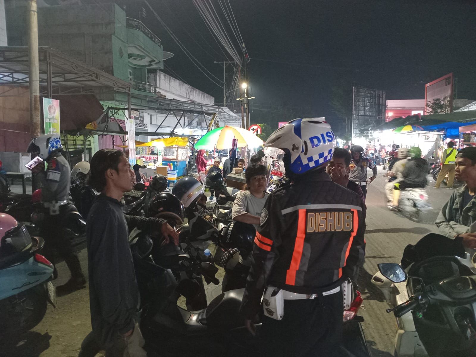 Petugas Dishub Kota Palu melakukan pengawasan juru parkir di kawasan pertokoan untuk memastikan tarif parkir sesuai ketentuan pemerintah daerah.