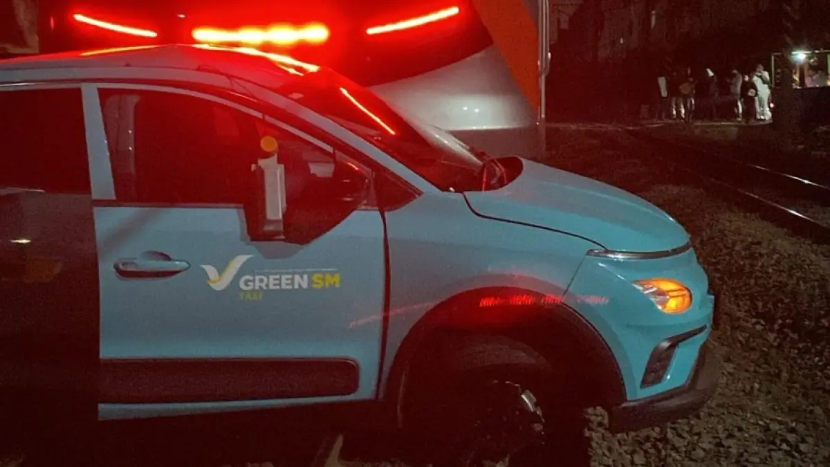 Kendaraan milik Green SM Indonesia yang berada di area perlintasan saat kereta melintas.(Twitter/@Ag_Crypto0)
