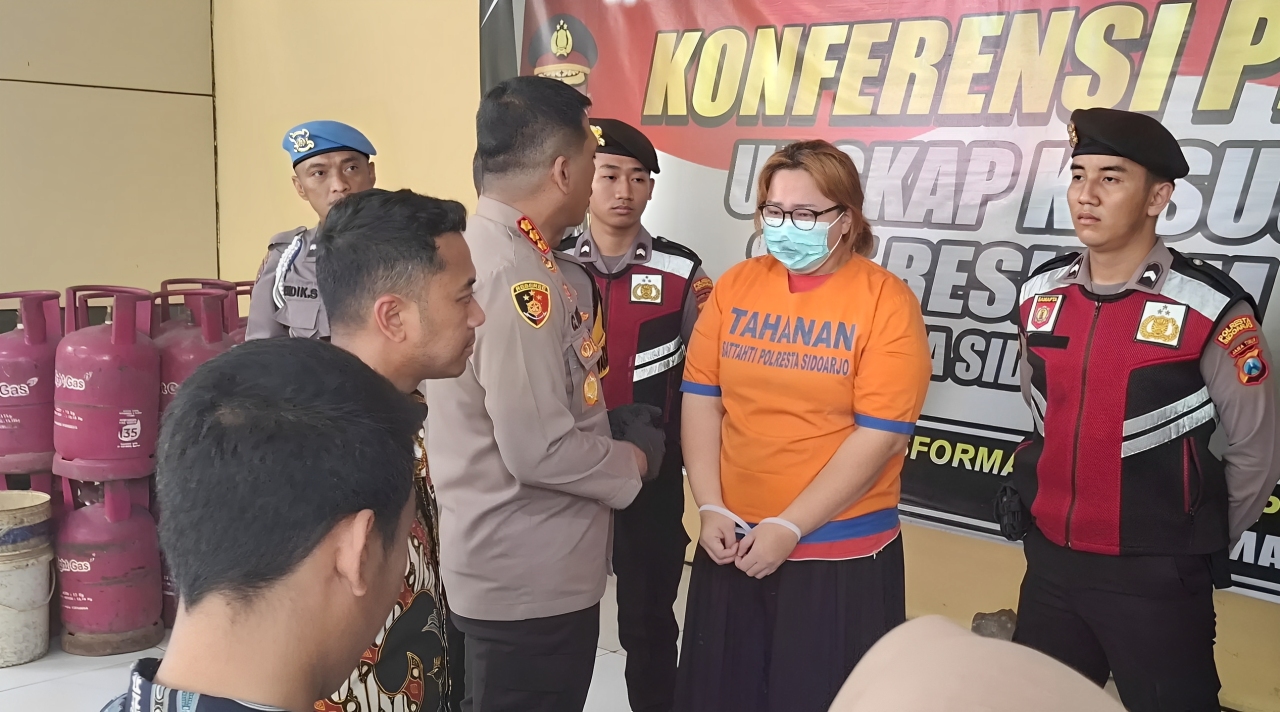 Tersangka RAW diamankan Unit PPA Satreskrim Polresta Sidoarjo. Ia tega menyiram anaknya menggunakan air panas di kepala, wajah, dan punggungnya.