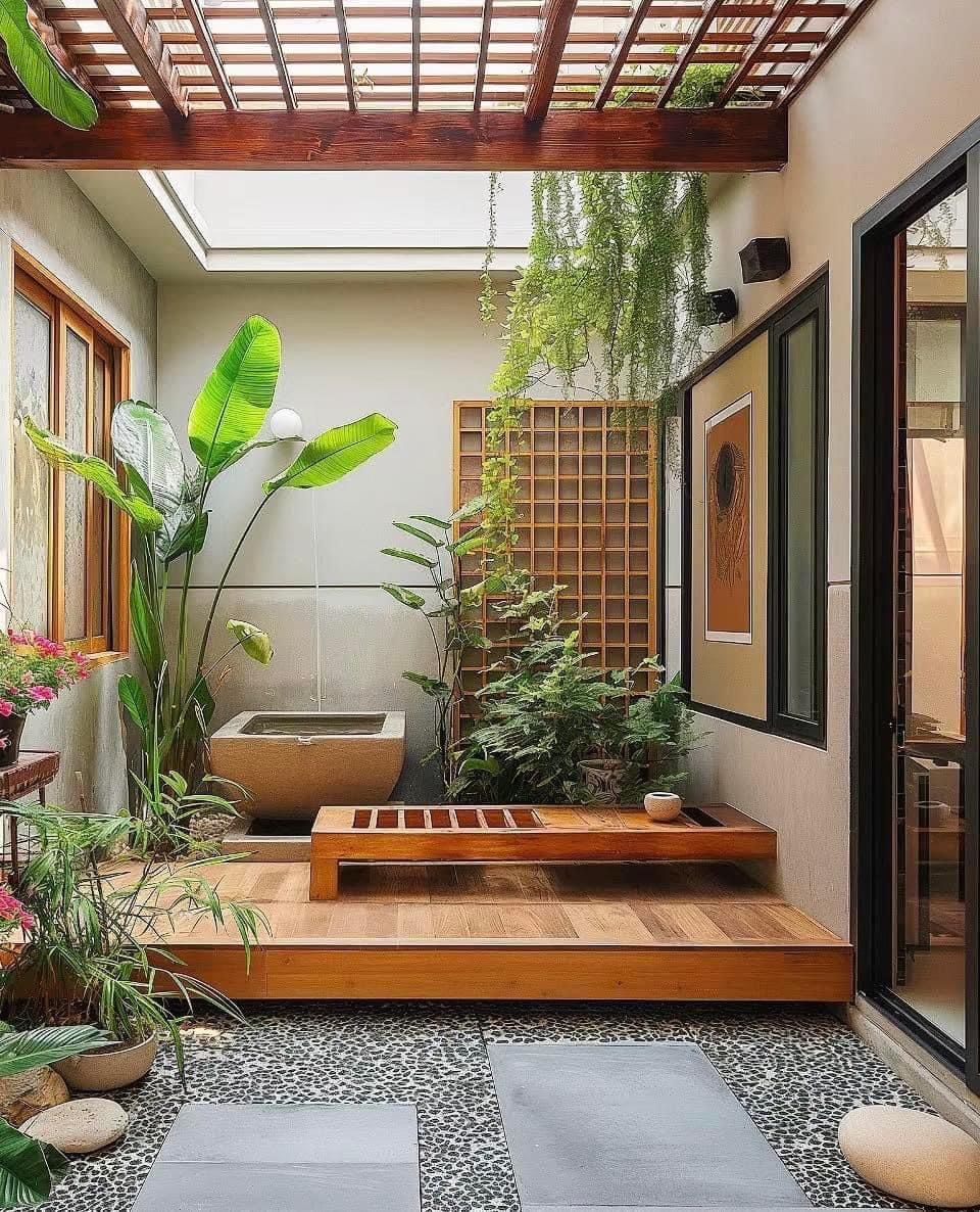 Desain rumah minimalis modern dengan elemen Zen seperti batu alam dan kayu hangat, menciptakan suasana yang tenang dan harmonis.