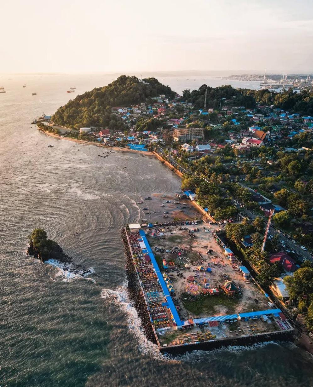 Suasana sore di Pantai Melawai Balikpapan dengan latar laut, kapal, dan langit jingga yang memikat &mdash; spot sunset populer yang wajib dikunjungi.