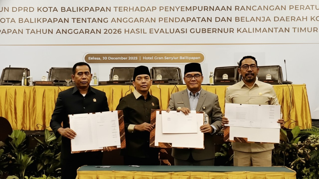Sejumlah pejabat Pemerintah Kota Balikpapan menunjukkan dokumen hasil penetapan APBD 2026 usai rapat di Hotel Gran Senyiur, Balikpapan, Selasa (30 Desember 2025).