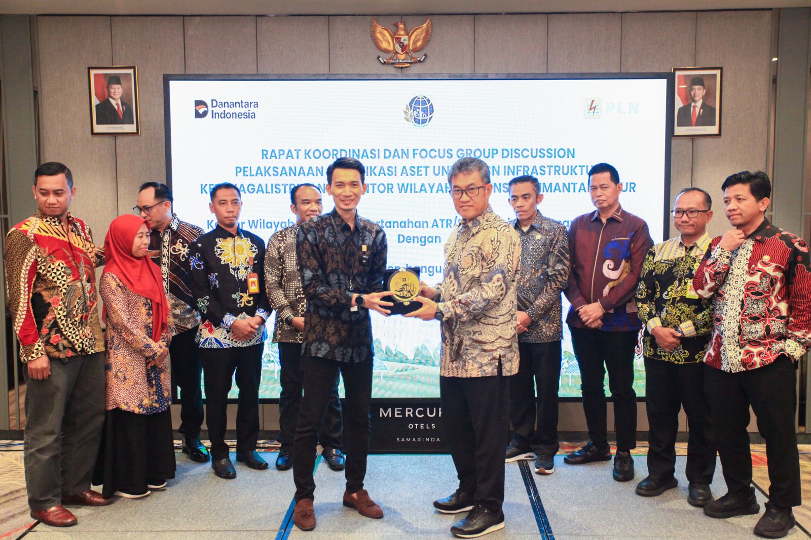 Penyerahan plakat penghargaan PLN kepada BPN Kalimantan Timur sebagai simbol kolaborasi pengamanan aset ketenagalistrikan.