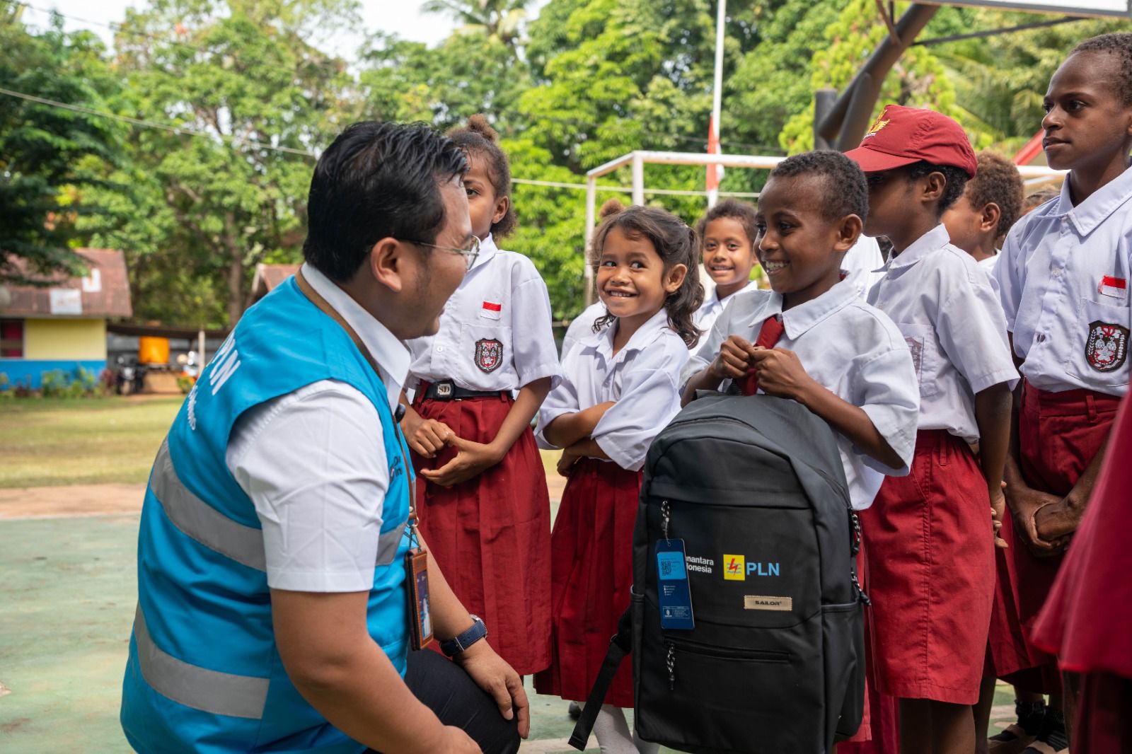 Salah satu siswa Sekolah Dasar Inpres Gudang Arang Merauke, Papua Selatan, tampak bahagia saat menerima paket perlengkapan sekolah berupa tas dan alat tulis dari Danantara Indonesia melalui PLN. 