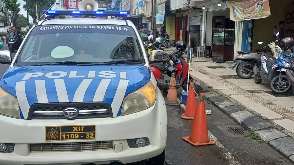 Petugas Satlantas Polresta Balikpapan menempel barcode ETLE pada kendaraan parkir liar di kawasan KTL Jalan Sudirman.