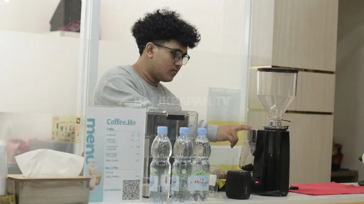 Barista Coffee Ho sedang membuat kopi aren dan melayani pelanggan di cafe unik kawasan Terminal Batu Ampar. (BTV/AI)