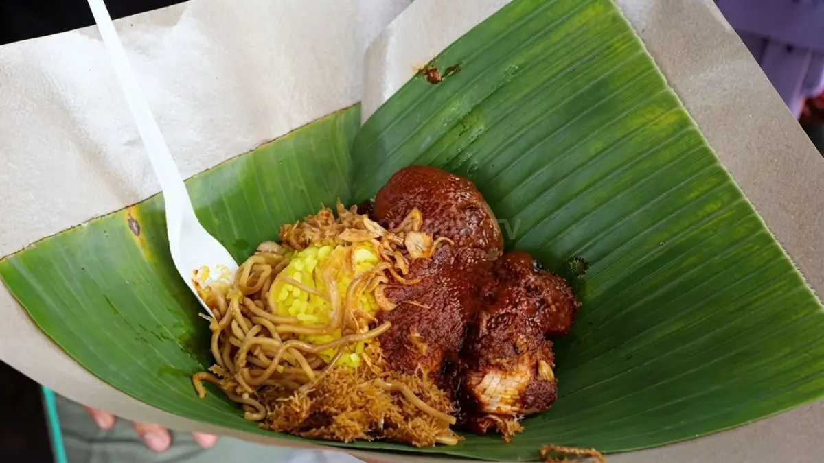 Nasi kuning lengkap menghadirkan perpaduan tongkol, telur pindang, serundeng, dan sambal habang khas Balikpapan. (Sumber: YouTube Tanboy Kun)
