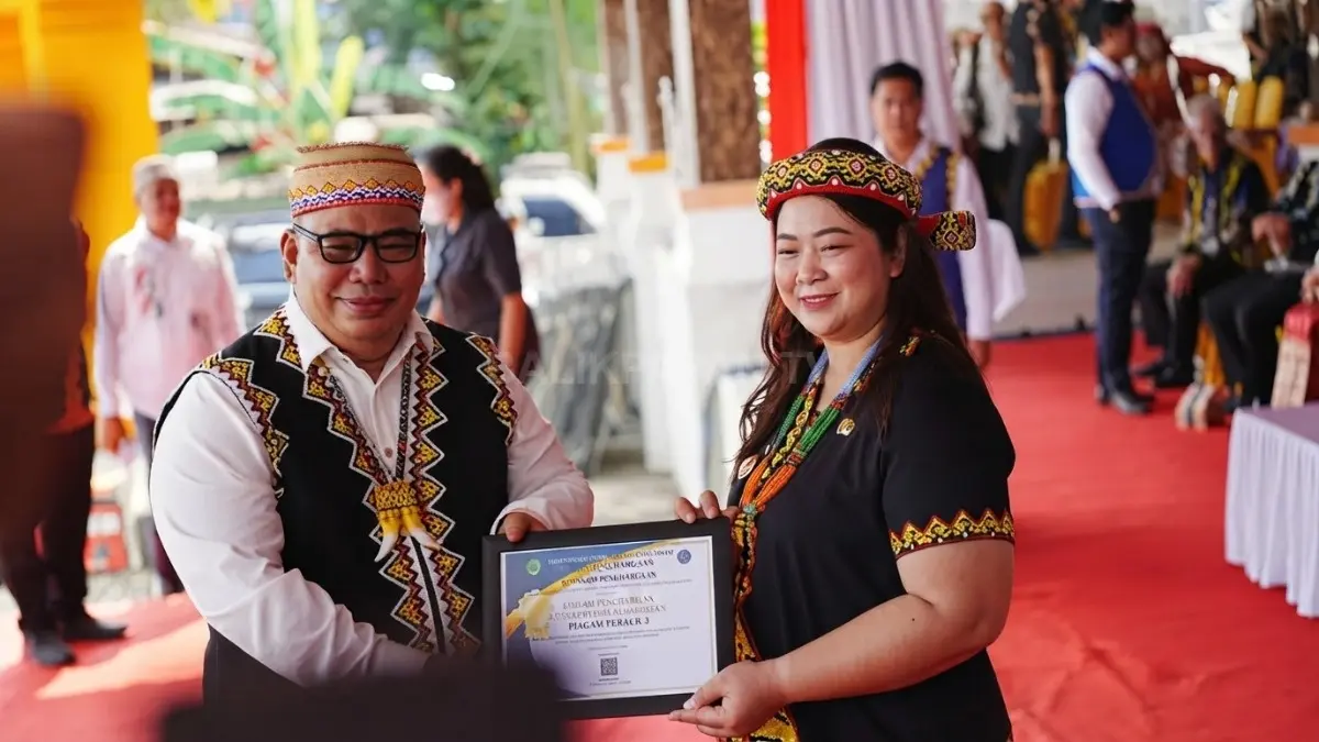 Kadishub FX Lawing menyerahkan penghargaan Dishub Mahulu sebagai Pembina Terbaik 3 kepada Angela Idang Belawan (DOK. JODY KRISTIANTO/KP)