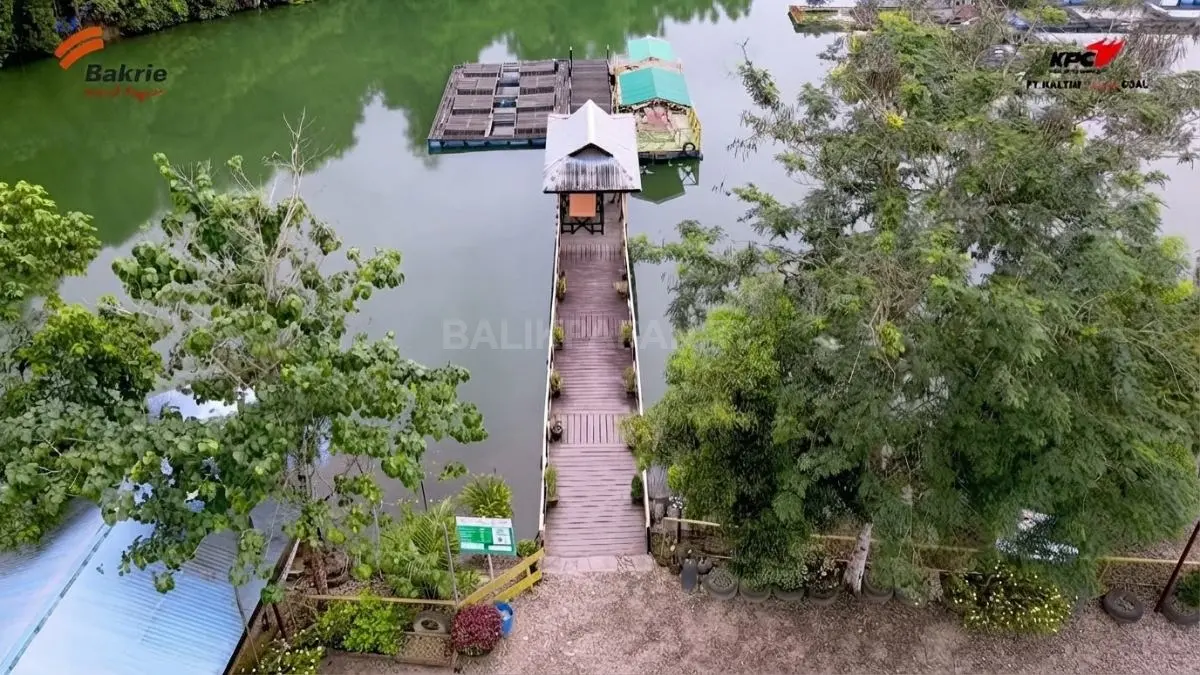 Telaga Batu Arang Sangatta membentang di kawasan reklamasi bekas tambang dengan lanskap hijau di sekelilingnya.