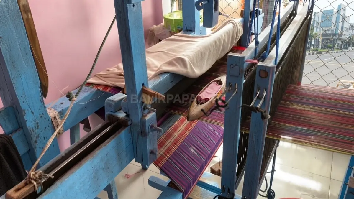 Benang digulung secara manual sebagai salah satu tahapan sebelum proses pembuatan sarung Tajong.