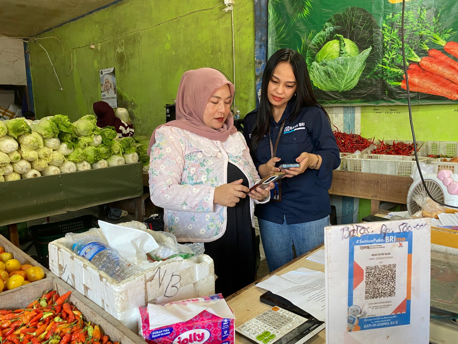Agryd Wyanndari bertemu Faidah, pedagang Pasar Besar Palangka Raya yang telah aktif menggunakan Qris. GILANG/KALTENG POS