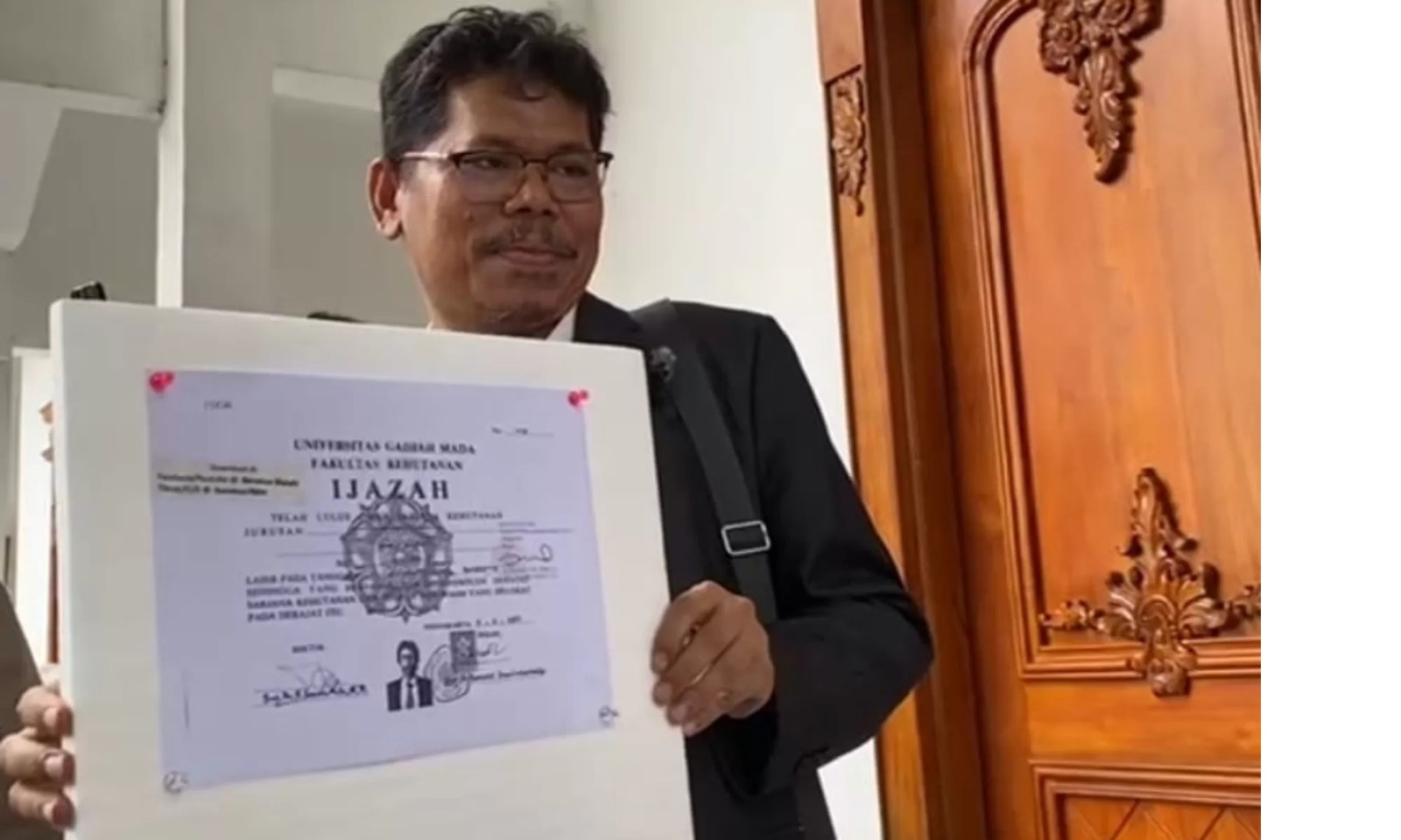 Pengamat kebijakan publik Bonatua Silalahi memamerkan salinan ijazah Presiden ke-7 RI Joko Widodo (Jokowi) di halaman Kantor Komisi Pemilihan Umum (KPU) RI, Jakarta, Senin (9/2). (Istimewa)