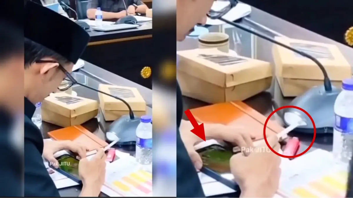 Tangkapan layar anggota DPRD Jember main game dan merokok saat rapat.