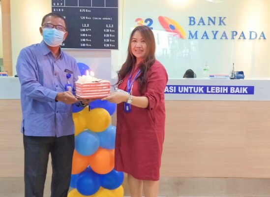 KEJUTAN: Direktur PT Kalteng Pos Press Dr HM Wahyudie F Dirun memberikan kue ulang tahun kepada Pemimpin Bank Mayapada Cabang Palangka Raya Olga Maya, Rabu (16/3).