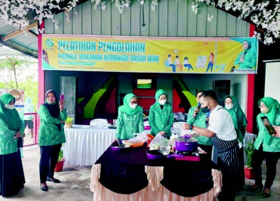 DEMO MASAK: Ketua TP PKK Kota Palangka Raya Avina Fairid Naparin saat memimpin kegiatan pelatihan pengolahan produk makanan berbahan dasar ikan di Kebun Larossa, Minggu (14/8).