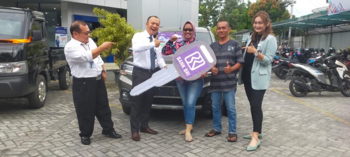 SERAH TERIMA : Pemimpin BRI Cabang Palangka Raya Bobby Bayu Nurzaman (dua dari kiri) saat menyerahkan grand prize I kepada pemenang undian Simpedes, Lengga Widi Astuti (tengah), Senin (5/12).