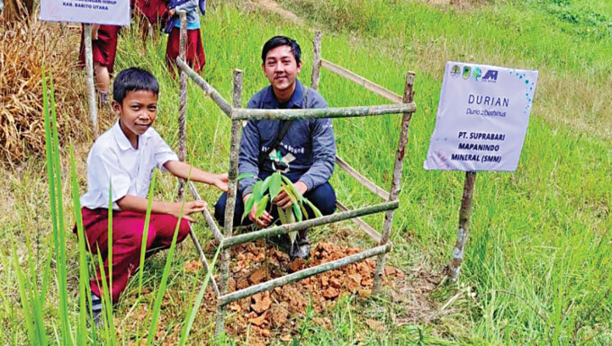 PROGRAM CSR: Perwakilan Pimpinan PT SMM saat penanaman dan pembagian bibit pohon buah bersama BKSDA SKW III Muara Teweh, melibatkan murid SDN 3 Lemo II Dusun Pararawen, Kecamatan Teweh Tengah, Senin (28/11).