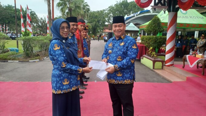 BERIKAN BONUS: Bupati Kotim H Halikinnor memberikan bonus kepada salah satu OPD yang mengikuti defile terbaik, Rabu (29/11/23). ( FOTO : BAHRI/KALTENG POS )