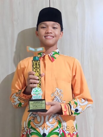 MEMBANGGAKAN: Muhammad Firja Fawwaz, Penghafal 30 Juz Al-Qur’an menunjukan trofi juara MTQH XXXI Tingkat Provinsi Kalteng di Pangkalan Bun tahun 2023.  FOTO: IRPAN JURAYZ/KALTENG POS