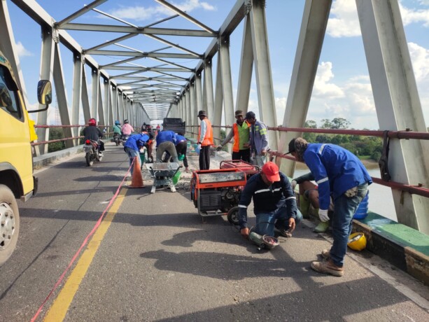 MULAI DIPERBAIKI: Sejumlah tenaga kerja melakukan pembongkaran lantai Jembatan Sei Katingan, Minggu (14/7/2024).