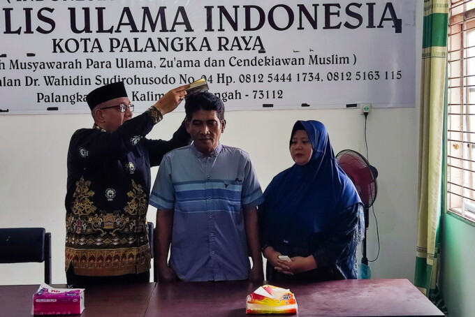 BERSUMPAH: Pemilik usaha Bakso Mas Bejo, Joko dan istrinya, bersumpah di atas Al-Quran untuk membuktikan bahwa mereka tidak pernah dengan sengaja memasukkan tikus ke dalam tempat pengolahan makanan, di Kantor MUI Palangka Raya, Rabu (23/10/2024).