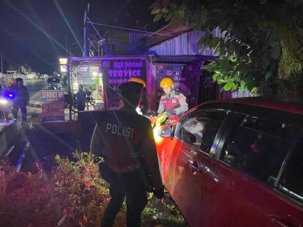 SIGAP: Personel Unit Pammat Subdit Gasum Ditsamapta Polda mengevakuasi mobil yang mengalami terperosok ke dalam parit di Jalan Seth Adji. HUMAS