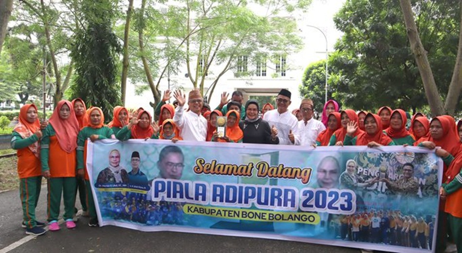 Bupati Merlan S. Uloli didampingi Sekda Ishak Ntoma dan Kepala DLHPP Kusno berpose bersama Petugas Kebersihan saat penyambutan penghargaan Piala Adipura, di Halaman Kantor Bupati. (F.Tim IKP)